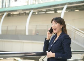 Is VoIP is the Future of Telecommunications Business woman on mobile phone