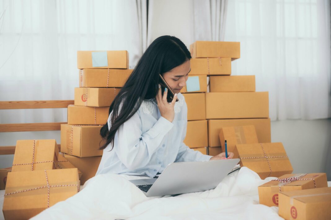 Small business owner boxes talking on phone