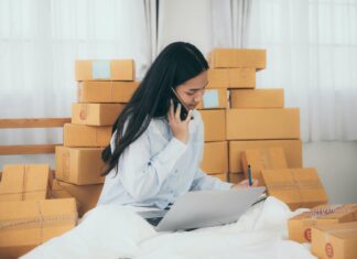 Is VoIP Suitable for Small Businesses? Small business owner boxes talking on phone