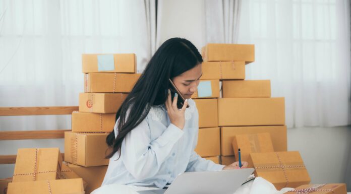 Is VoIP Suitable for Small Businesses? Small business owner boxes talking on phone