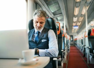 How Does VoIP Impact Telecommuting Trends? Man working on train