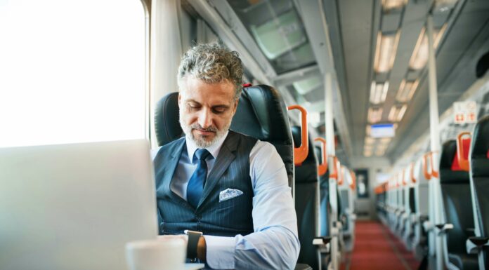 How Does VoIP Impact Telecommuting Trends? Man working on train