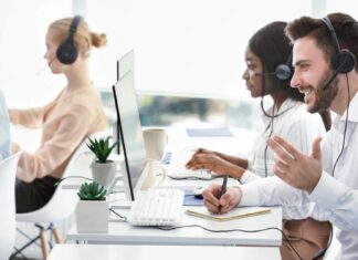 What Are the Key Differences Between VoIP and PBX Systems? Employees Using VoIP Systems