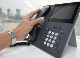 Are VoIP Solutions Compatible with Legacy Phone Systems? Person Using VoIP System