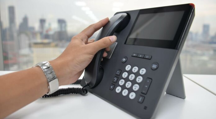 Are VoIP Solutions Compatible with Legacy Phone Systems? Person Using VoIP System