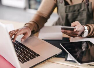 Broadband Accessibility: The Impact On Small Businesses Small Business Owner Using Mobile And Laptop