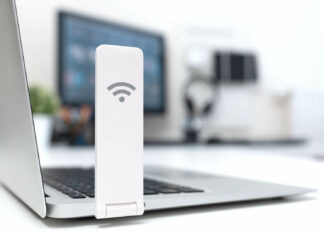 How Does Broadband Usage Vary Across Different Demographics? WiFi Dongle On Laptop