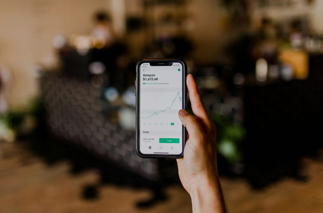 Unrecognisable person making a financial transaction on their phone