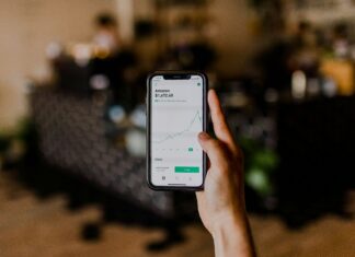 Can VoIP Systems Support Secure Financial Transactions? Unrecognisable person making a financial transaction on their phone