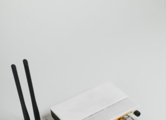 What are the Social Impacts of Broadband Internet Adoption? Photo of a white internet hub with a black modem