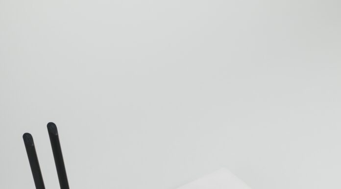 What are the Social Impacts of Broadband Internet Adoption? Photo of a white internet hub with a black modem