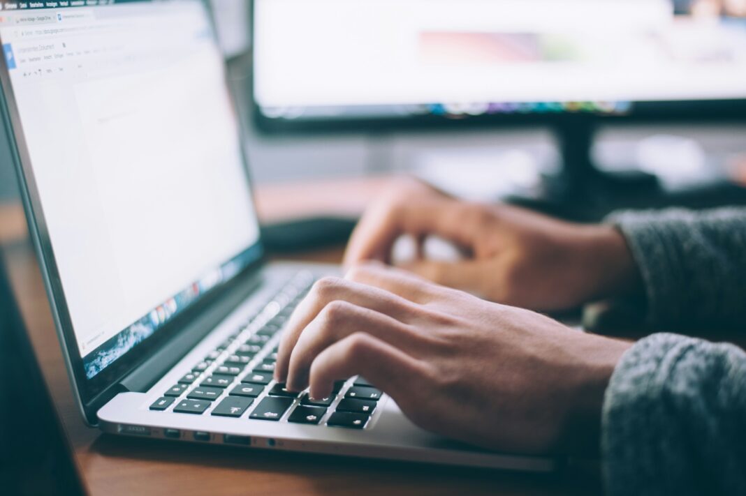 Man typing on his laptop