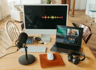 How Does Broadband Shape Digital Media Consumption Habits? Photo of a screen, microphone, and laptop busy recording video and audio