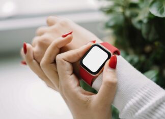 What Are the Privacy Concerns Surrounding Connected Devices? A woman wearing a smart watch around her wrist with a red strap