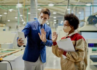 Why Every Small Business Should Consider VoIP Man and woman wearing masks video calling someone on a tablet