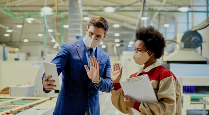 Why Every Small Business Should Consider VoIP Man and woman wearing masks video calling someone on a tablet