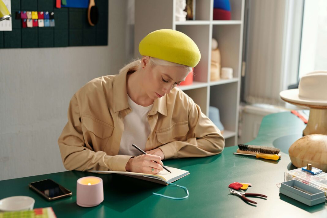 Woman sitting at her desk drawing on a piece of paper