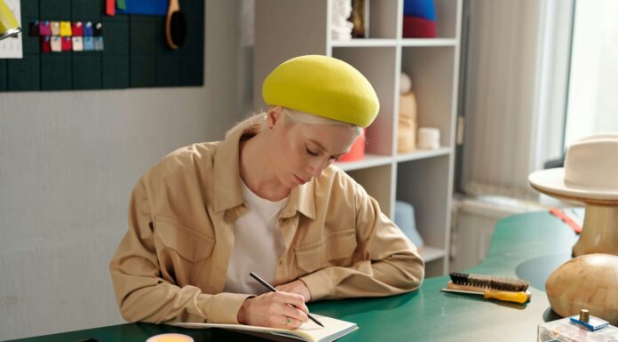 The Best VoIP Phones for Small Businesses Woman sitting at her desk drawing on a piece of paper