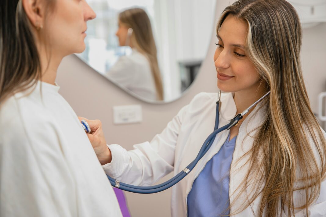 What Are the Key Benefits of Connectivity in the Healthcare Sector? A dr. using her stethoscope to listen to a patient's heart