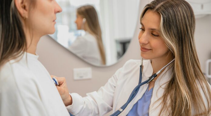 What Are the Key Benefits of Connectivity in the Healthcare Sector? A dr. using her stethoscope to listen to a patient's heart