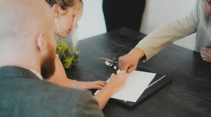 5 Questions to Ask Before Signing a Business Broadband Contract A woman sitting at a table signing a contract