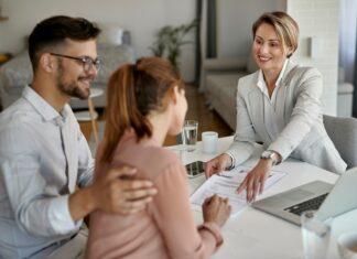 8 Reasons Real Estate Agents Should Use VoIP A couple signing a contract while sitting across from a real estate agent
