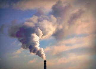 Can VoIP Reduce Carbon Emissions in Large Businesses? A factory emitting harmful gas into the sky