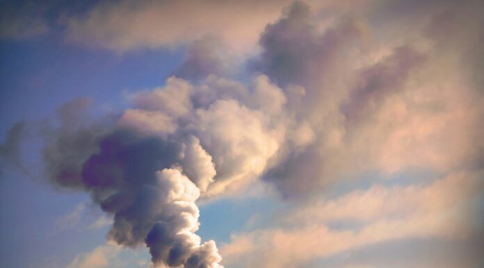 Can VoIP Reduce Carbon Emissions in Large Businesses? A factory emitting harmful gas into the sky