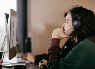 Do I Need a Special Router For VoIP? A man sitting at a desk looking at a computer screen with a headset on