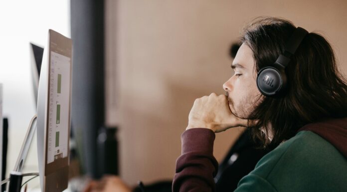 Do I Need a Special Router For VoIP? A man sitting at a desk looking at a computer screen with a headset on