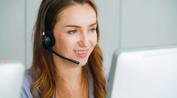 How to Choose the Right Headset for VoIP Calls A woman sitting in front of her computer screen with a headset on