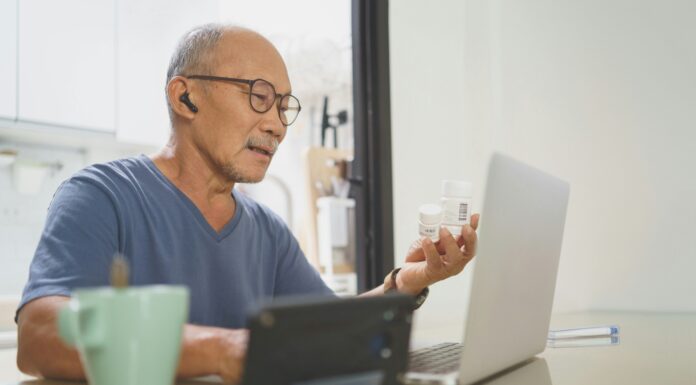 Why Are VoIP Adapters Useful? A man sitting at his laptop with earphones and a mug of coffee