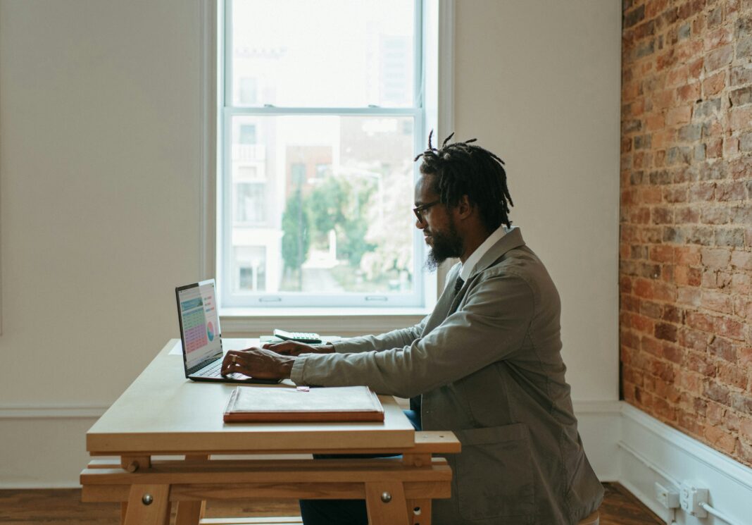 Why Do I Need a VoIP Adapter? A man sitting at his desk working remotely on his laptop