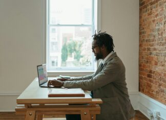 Why Do I Need a VoIP Adapter? A man sitting at his desk working remotely on his laptop