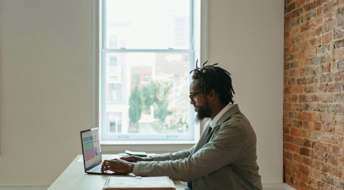 Why Do I Need a VoIP Adapter? A man sitting at his desk working remotely on his laptop