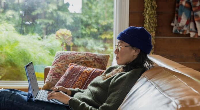 Why Full Fibre is Essential for UK Businesses in 2025 A woman sitting on a couch working on her laptop