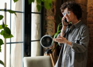Can I Use an eSIM and a Physical SIM At the Same Time? A woman standing in a studio talking on the phone