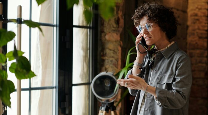 Can I Use an eSIM and a Physical SIM At the Same Time? A woman standing in a studio talking on the phone