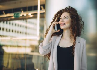 How Do eSIMs Work? A woman standing outside an office talking on the phone