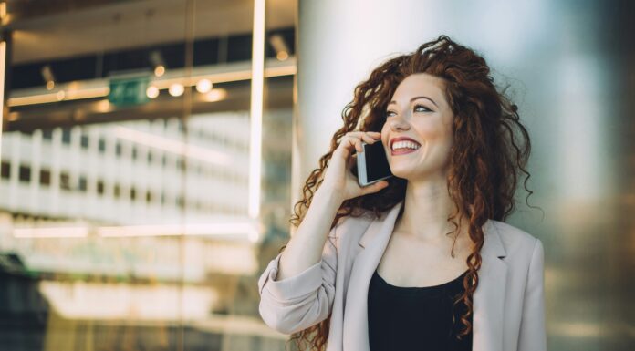 How Do eSIMs Work? A woman standing outside an office talking on the phone