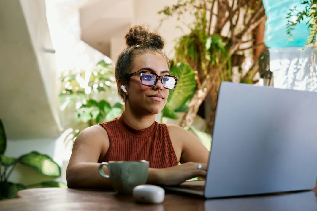 A woman sitting at her desk working on her laptop