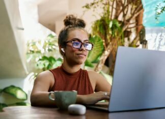Is VoIP the Right Choice for Home-Based Businesses? A woman sitting at her desk working on her laptop