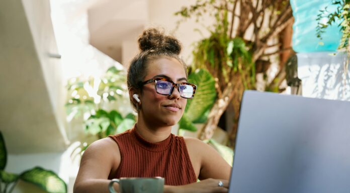 Is VoIP the Right Choice for Home-Based Businesses? A woman sitting at her desk working on her laptop