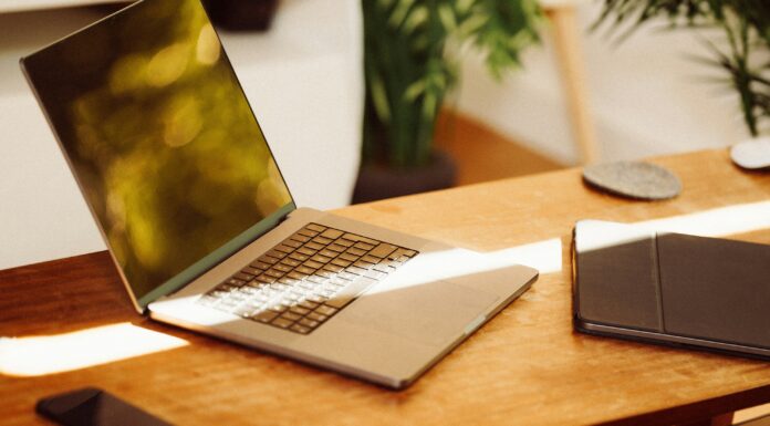 Understanding Which UK City Has The Fastest Internet Speeds A photo of a laptop sitting on a wooden desk with a beam of sunlight shining over it
