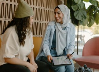 What Is Connectivity and Why Does It Matter? Two women sitting on a couch in an office with a tablet
