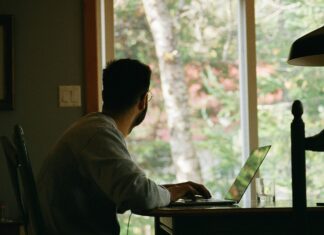 How VoIP Technology Can Help Your Business Scale man-sitting-at-his-desk-looking-out-a-window