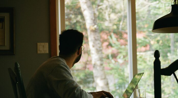 How VoIP Technology Can Help Your Business Scale man-sitting-at-his-desk-looking-out-a-window