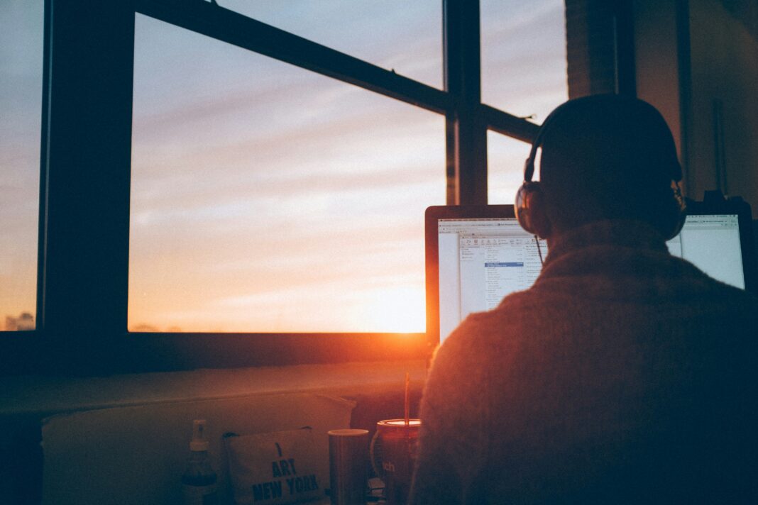 man-with-headphones-working-on-a-computer