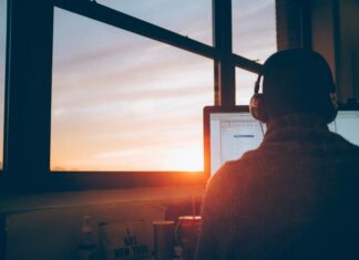 How to Choose VoIP Features Based on Your Business Needs man-with-headphones-working-on-a-computer