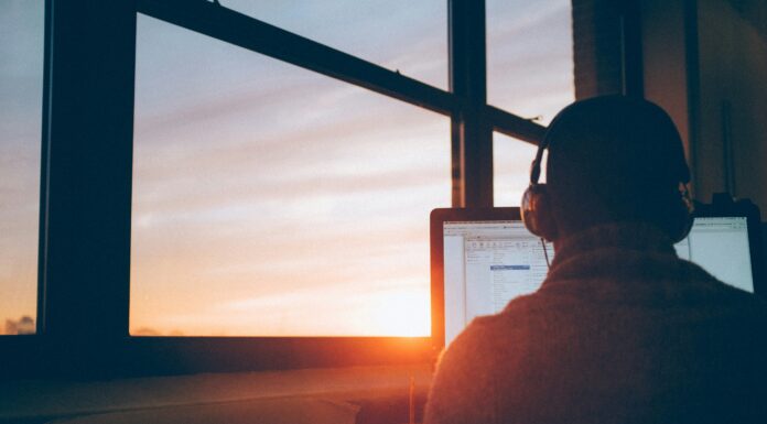 How to Choose VoIP Features Based on Your Business Needs man-with-headphones-working-on-a-computer